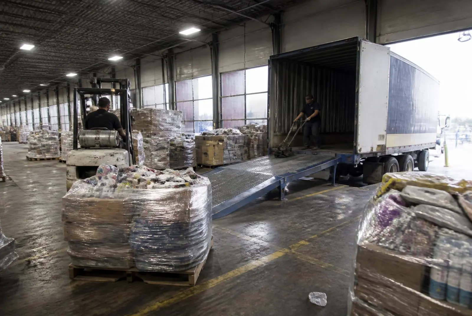 Wholesale liquidation pallets staged for shipping in Houston, Texas Loading dock stacked with wholesale liquidation pallets of customer returns ready for nationwide shipment