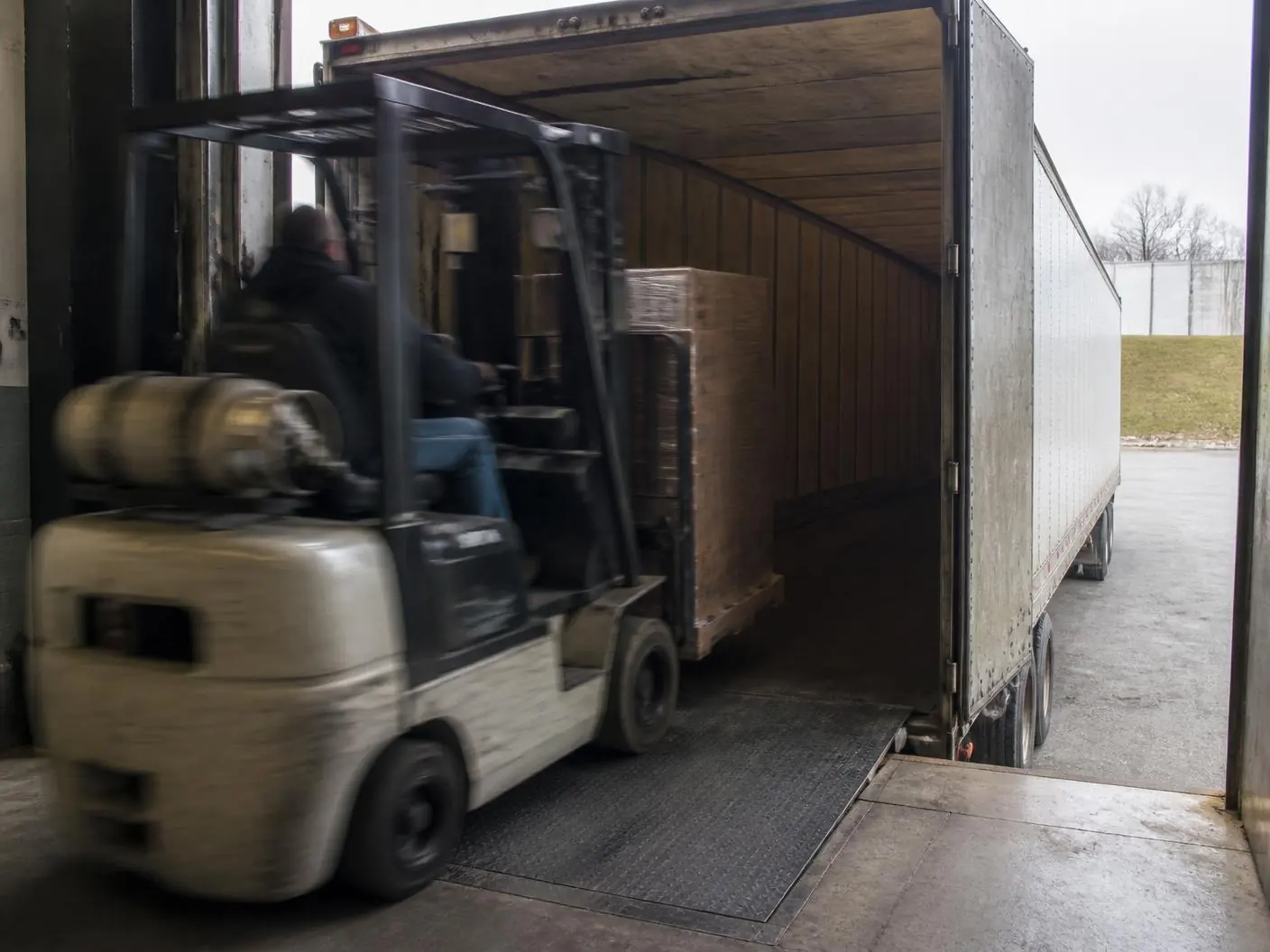 Truckload freight loading at the Houston outbound dock Forklift loading wrapped pallets into a 53 foot trailer